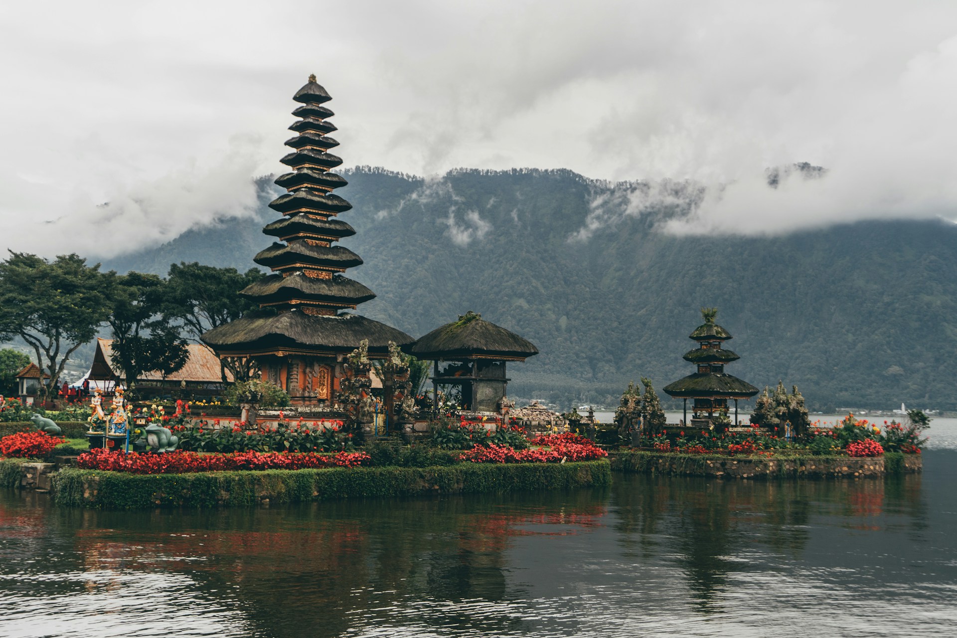 Balinese temple beside a lake with mountains and misty scenery in Bali Balinese temple beside a lake with mountains and misty scenery in Bali